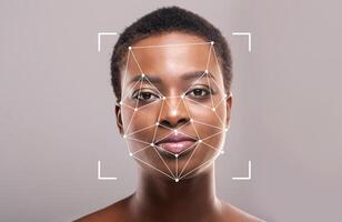 A woman appears with a facial recognition overlay showcasing the points of data collected for identification. This technology highlights advancements in security and personal identification. photo
