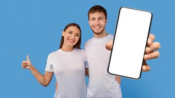 Happy couple showing thumbs up gesture and hugging isolated over pastel purple studio wall, banner, free space photo