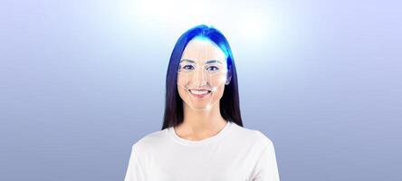 A young woman with a bright smile demonstrates advanced facial recognition technology. This scene is set against a soft, isolated background, highlighting the technology's capabilities. photo