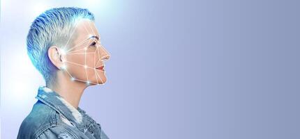 A woman is highlighted against a plain background, demonstrating facial recognition technology. The digital overlay outlines her facial features, signifying advancements in identification methods. photo