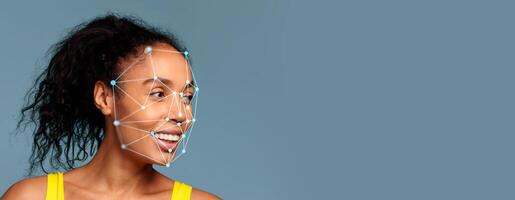 A woman with curly hair smiles as facial recognition technology identifies features on her profile. The backdrop is a calm blue color, creating a focus on her expression. photo