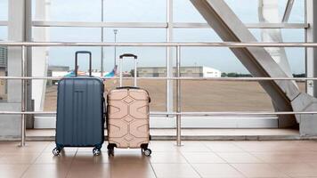 Shot Of Two Stylish Suitcases Standing Near Window At Empty Airport, Hand Luggage Or Cabin Baggage Size Bags Waiting In Terminal, Advertisement Banner For Air Travels And Flight Bookings, Copy Space photo