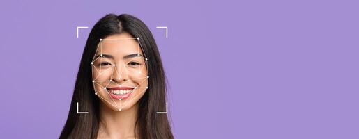 A smiling individual is shown with facial recognition markers on their face against a purple backdrop. The image emphasizes technology used for identification and security purposes. photo