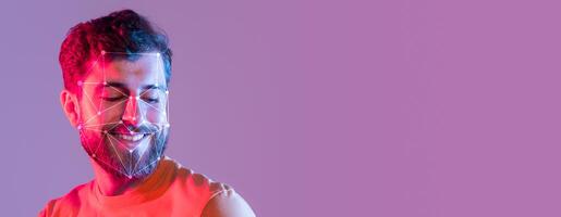A man with a beard smiles while a facial recognition overlay highlights key features. The vibrant background adds a modern touch, showcasing advances in identification technology. photo