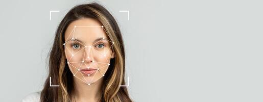 A woman is featured with facial recognition markers superimposed on her face. This technology highlights key facial features for identification. The background is a neutral, empty space. photo