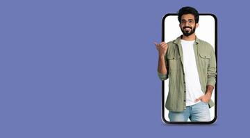 A young man smiles while interacting through a smartphone with a large screen, showcasing the convenience of modern technology for social media and communication. photo