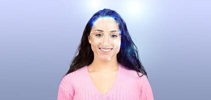 A woman smiles confidently while undergoing facial recognition technology. Her face is illuminated, highlighting the details and showcasing modern identification methods in a contemporary setting. photo