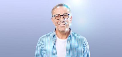 A smiling older man with glasses appears against a light purple backdrop. He is part of a demonstration highlighting modern facial recognition technology, emphasizing identification and security. photo