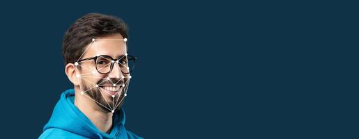 A smiling person with glasses has facial recognition technology overlaying their face. This showcases advanced identification technology in an isolated setting with a blank background. photo