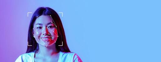 A person smiles as facial recognition technology is applied to their features. The background is brightly colored, highlighting the integration of technology and personal identification. photo