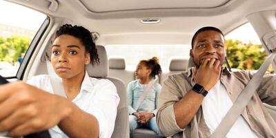 Scared Black Husband Biting Nails While Wife Driving Auto Having Danger Of Car Accident Sitting In New Automobile Inside. Family Riding Vehicle And Having Risk Of Crash. Transportation Concept photo