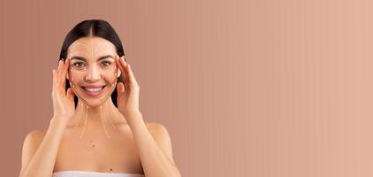 A woman enjoys a relaxing skin care routine, applying a facial treatment to enhance her beauty. She smiles while pampering herself in a peaceful setting with soft tones. photo