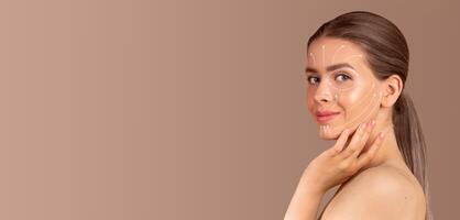 A woman engages in a skin care routine, applying pampering products on her face. She exudes calmness and confidence while surrounded by an empty, neutral background. photo