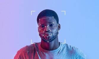 A person is shown with facial recognition technology applied, showcasing key features on a blue and pink backdrop. This depicts advancements in identification and security measures. photo