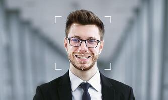 A man in formal attire smiles while facial recognition software identifies him. The background features soft architectural lines, enhancing the focus on identification technology. photo