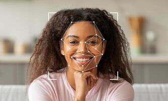 A woman with curly hair is smiling confidently while facial recognition technology detects her features. The background is blurred, emphasizing her expressions and the tech overlay. photo