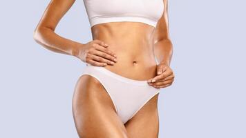 Body Neutrality. Closeup Cropped View Of Slim Lady With Perfect Ideal Shape Posing Isolated On Blue Studio Background, Lady In White Underwear Enjoying Herself, Touching Smooth Skin, Banner photo