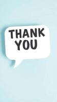 Bright and cheerful thank you speech bubble against a pastel background creates a friendly expression of gratitude photo