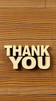 Thank you message crafted in bold letters against a wooden background adds warmth and appreciation to any occasion photo