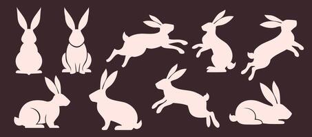 set of solid minimalistic flat rabbit silhouettes. Farm animal rabbit silhouette in different poses. Hare sitting, lying, running and jumping vector
