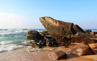 Frog Rock on Dalawella Beach in Sri Lanka on a sunny day. Holidays and vacations in Sri Lanka. Travel nature background photo