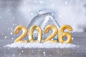 Golden figures number 2026 New Year against the background of tiny house with warm light and garlands. Greeting card, Happy New Year, cozy photo