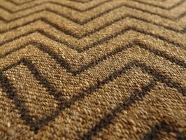 Close up of classic herringbone tweed fabric reveals earthy tones and zigzag pattern. Rugged texture enhances traditional design soft lighting highlighting craftsmanship photo