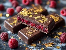 Rich dark chocolate showcases vibrant raspberry filling oozes gently complemented elegant gold leaf accents and fresh raspberries scattered around photo
