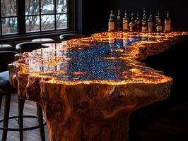bar counter showcases stunning design made of wood and epoxy resin featuring embedded LED lights illuminate glowing blue pattern enhancing upscale ambiance photo
