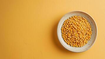 World Pulses Day banner with copy space. Bright yellow seed fill a round plate, showcasing their vibrant color against a matching backdrop. Natural texture and encourages healthy cooking choices. photo