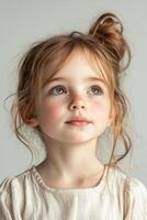A little girl with long hair and a white shirt photo