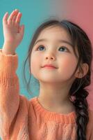 A little girl is raising her hand up in the air photo
