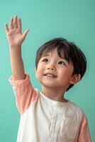 Asian child raising his hand to the sky photo