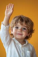 A young boy with his hand up in the air photo