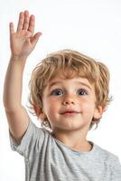 A young boy with his hand up in the air photo