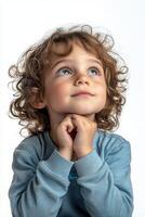 A young boy with curly hair looking up photo