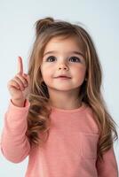 A little girl pointing at something with her finger photo