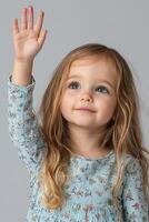 A little girl with long hair waving her hand photo