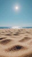 Sunny day at beach with soft sand and ocean view, bright sky. photo