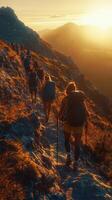Hikers on a mountain trail at sunset golden light, adventure trekking photo