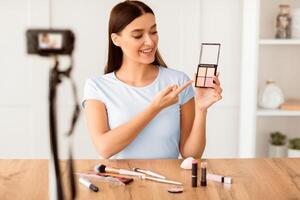 Beauty Blogger Making Makeup Tutorial Sitting In Front Of A Camera At Home. Blogging And Online Business. Selective Focus photo
