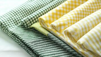 a stack of yellow and green gingham fabric photo