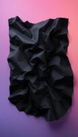 Crumpled black paper contrasts with a vibrant gradient background showing a rough texture photo