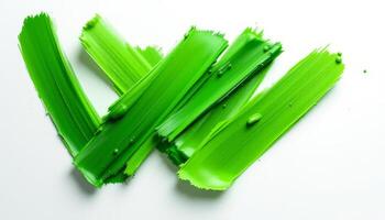 Abstract Strokes of Vibrant Green Paint on White Canvas photo