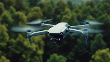 A grey drone hovers silently above a lush green forest canopy capturing scenic aerial footage photo