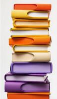 A vibrant and colorful stack of books arranged in a neat and visually appealing manner photo
