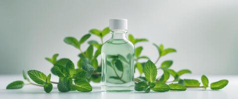 Mint extract bottle surrounded by fresh mint leaves for culinary and aromatic uses photo