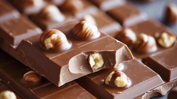 Delicious milk chocolate bars with hazelnuts showing bite mark photo