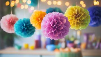 Colorful paper pom poms hanging at a festive birthday party photo