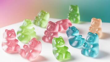 Colorful gummy bears sitting on white surface with pastel background photo